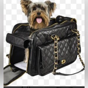 black quilted pet carrier tote with gold chain handles.